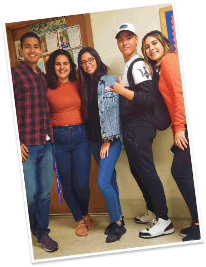 a group of students pose in school hallway